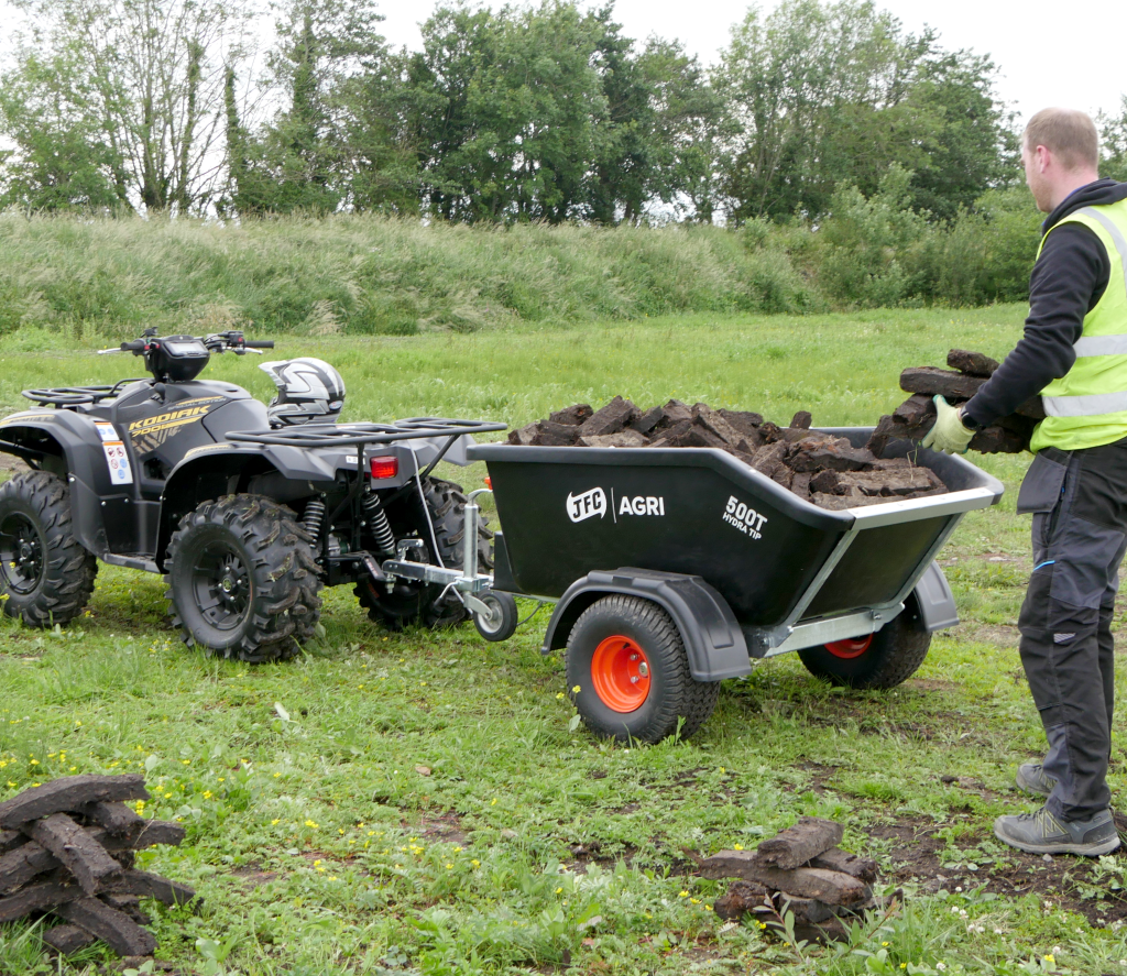 ATV Hydraulic Tipping Trailer (Black) being loaded with dirt