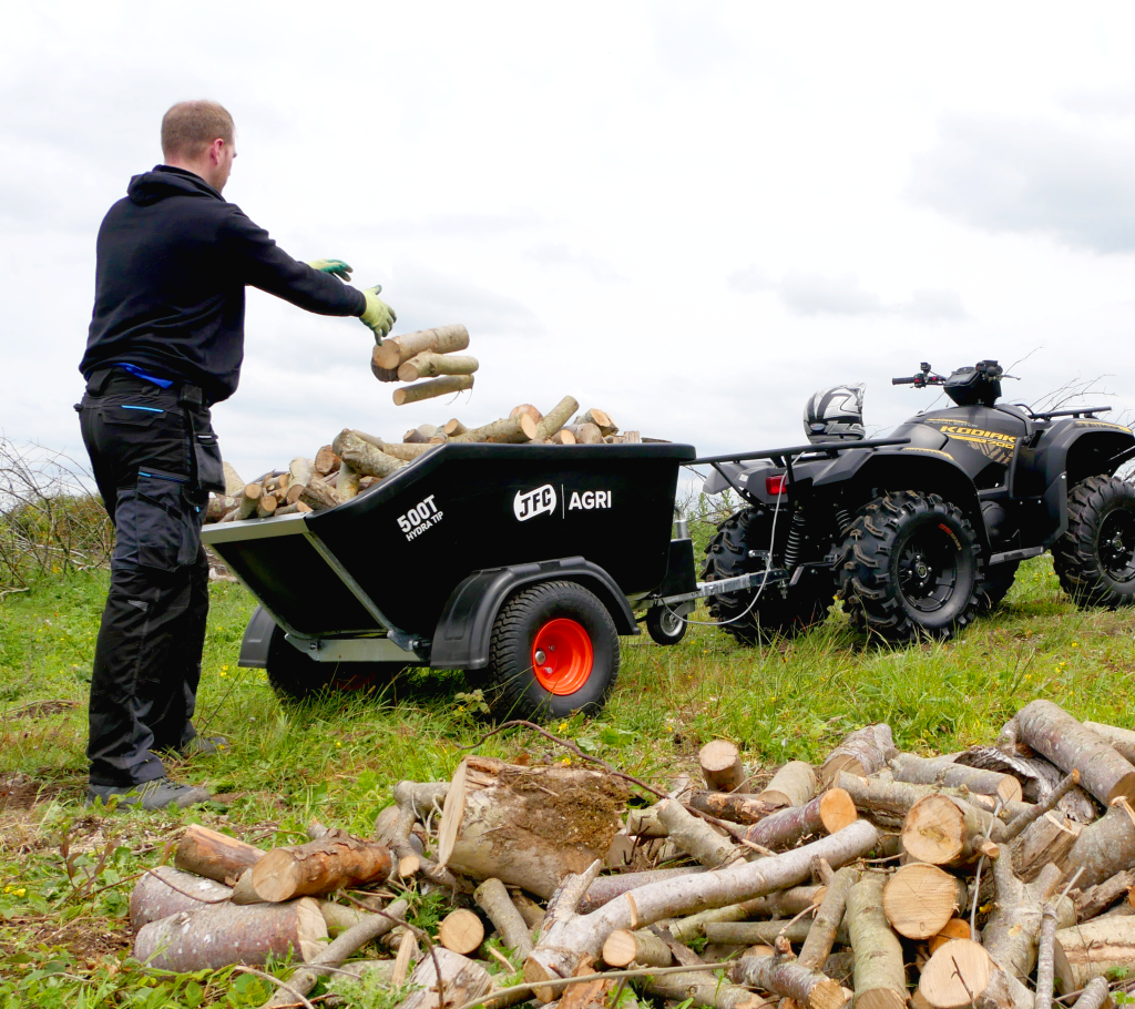 ATV Hydraulic Tipping Trailer (Black) being loaded with wood