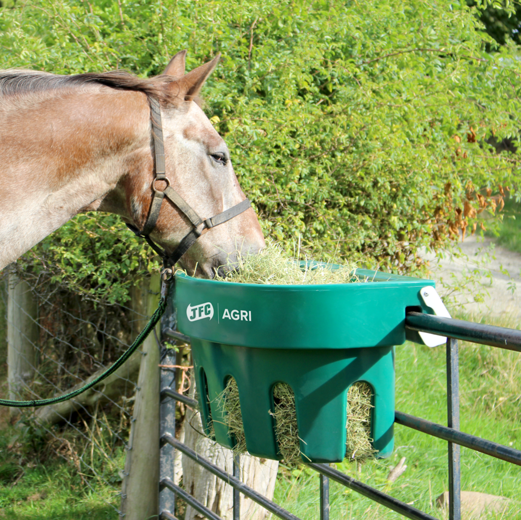 Gate Hay Feeder (Green) with horse eating from it