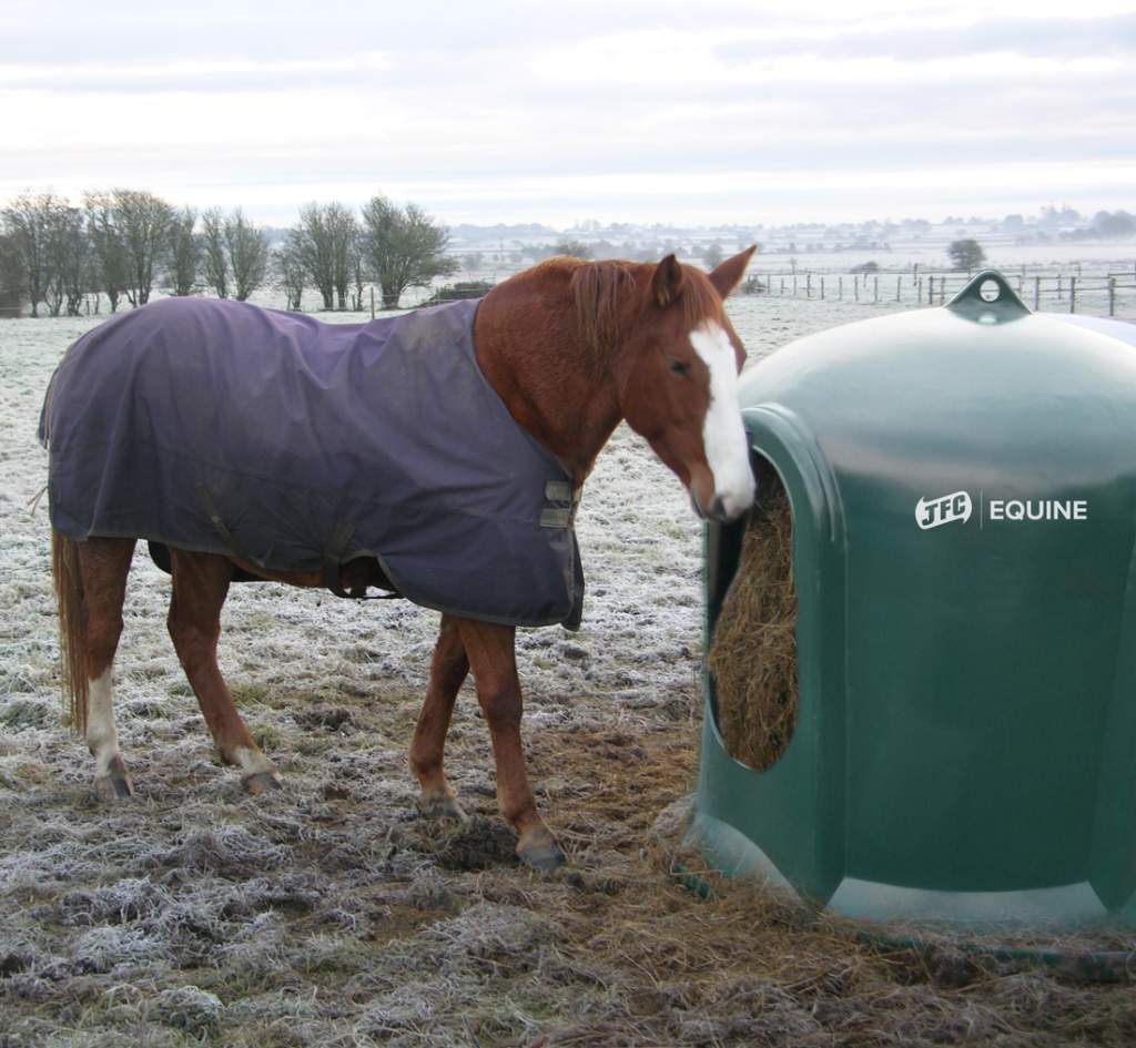 Horse Haybell with horse next to it in the snow