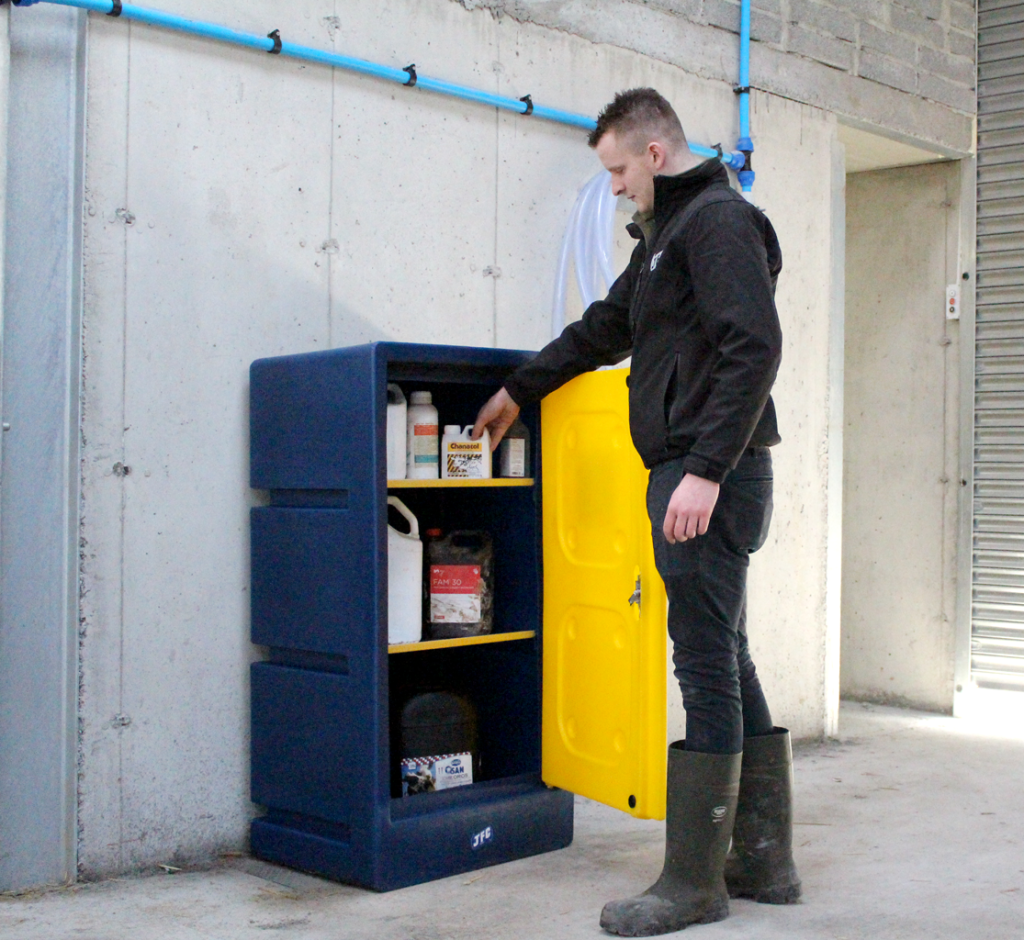 A medium navy & yellow chemical storage cabinet by JFC open showing farmer reaching for chemicals