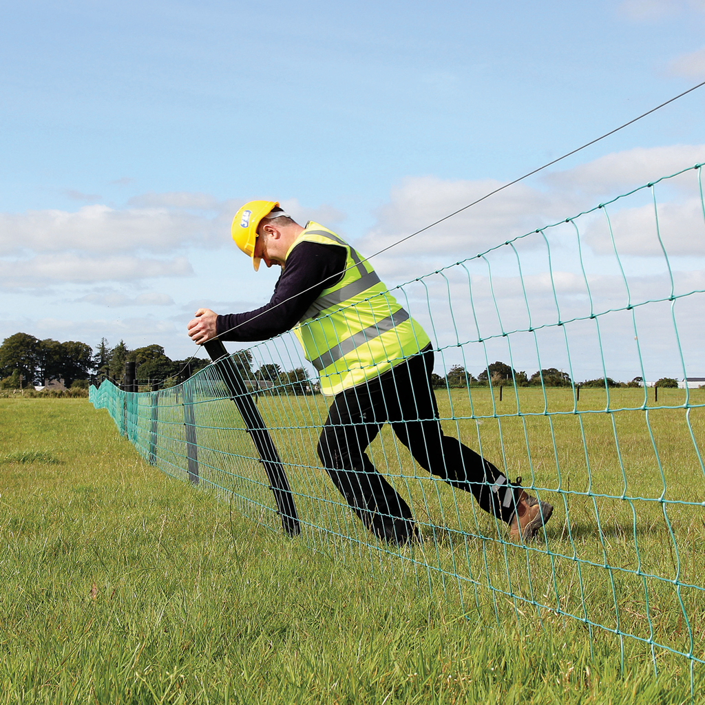 2g polyethylene hollow strainer fence post being bent by farmer to show flexibility