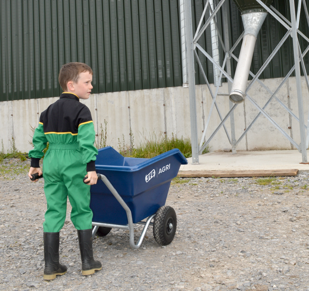 Junior Tipping Wheelbarrow (Blue) being held by child