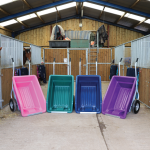 Pink, green, blue & purple 250 litre tipping wheelbarrow side by side